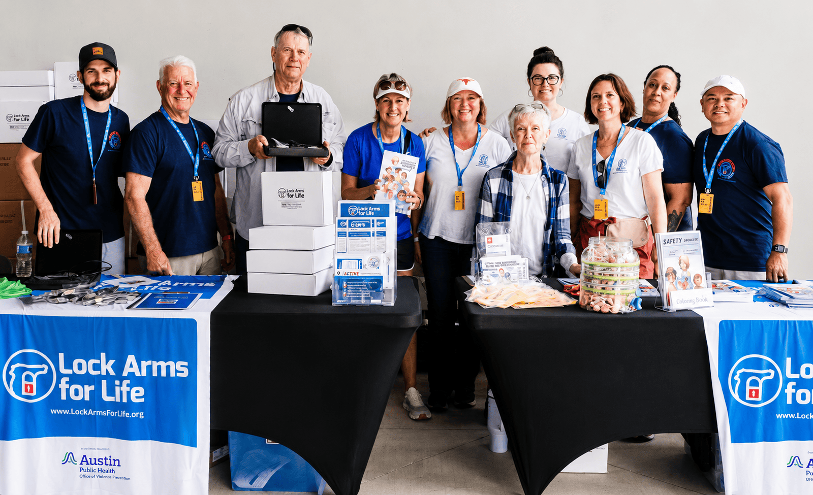 Lock Arms for Life staff and volunteers providing gun locks and firearm safety materials at a community event