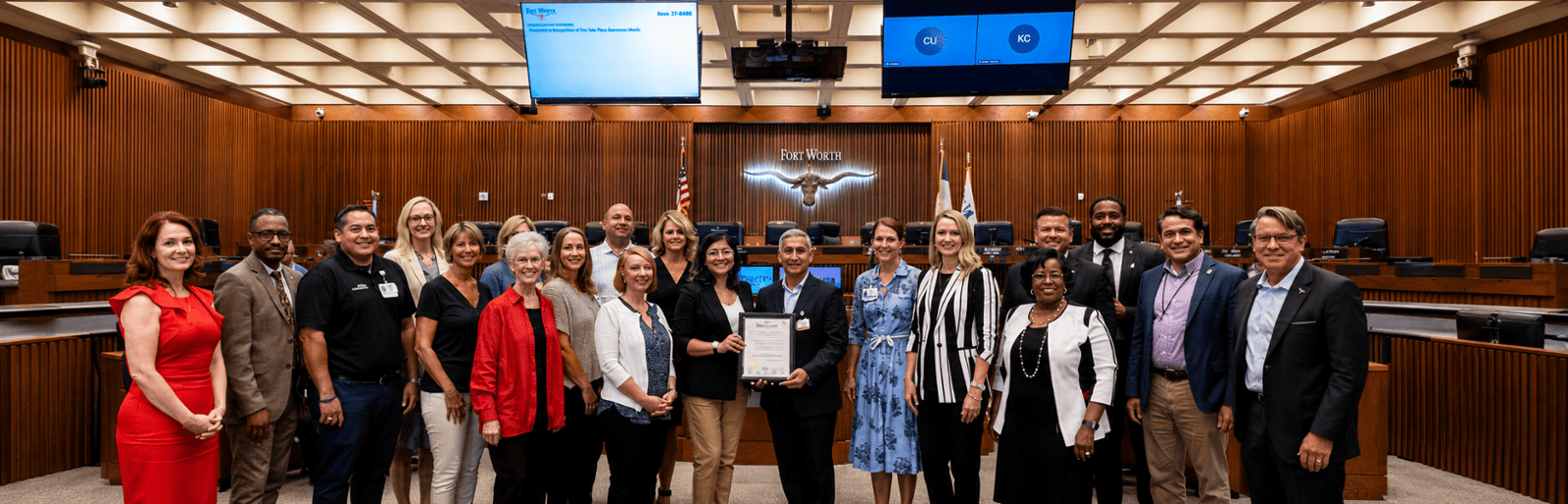 Community partners holding a Gun Safety Awareness Month proclamation in the Fort Worth City Council chamber