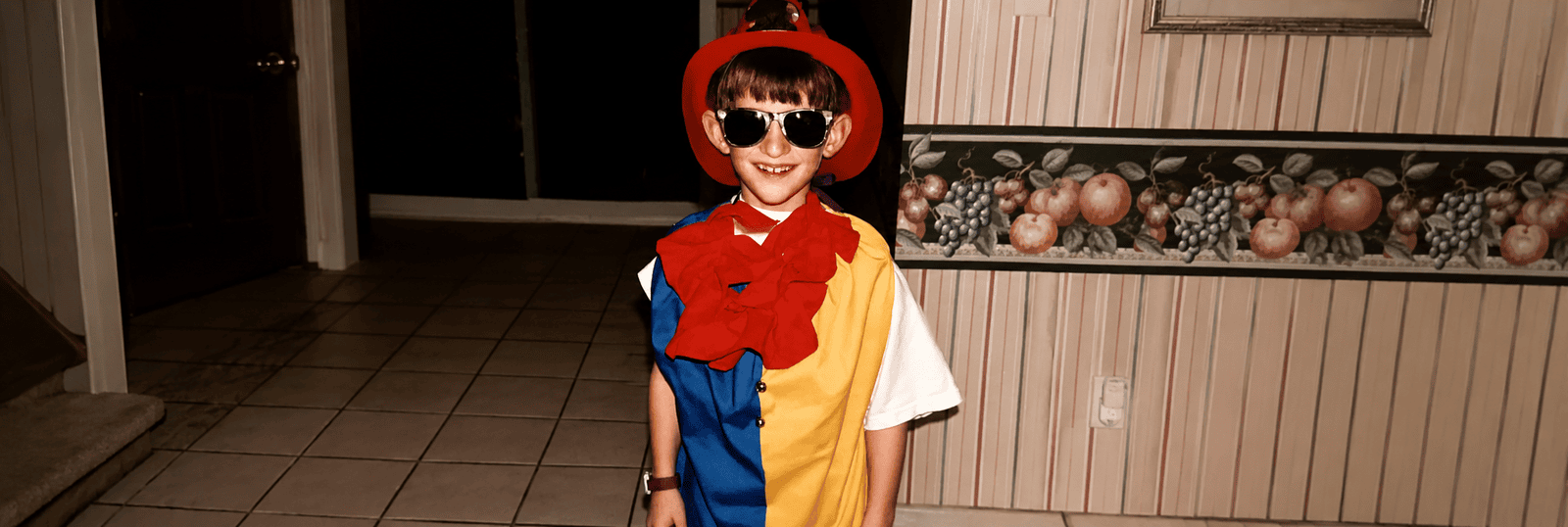 Childhood photo of Jon dressed as a clown and firefighter